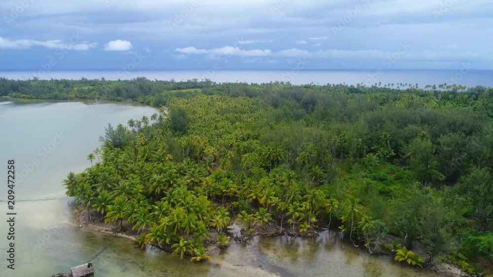 Aerial panoramic view of tropical paradise of Huahine island, Maeva village, lush tropic vegetation, dark sky foreseeing storm - South Pacific Ocean, panorama landscape of French Polynesia from above Aerial panoramic view of tropical paradise of Huahine island, Maeva village, lush tropic vegetation, dark sky foreseeing storm - South Pacific Ocean, panorama landscape of French Polynesia from above