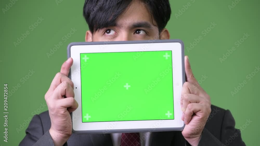 Young handsome Asian businessman using digital tablet Young handsome Asian businessman using digital tablet