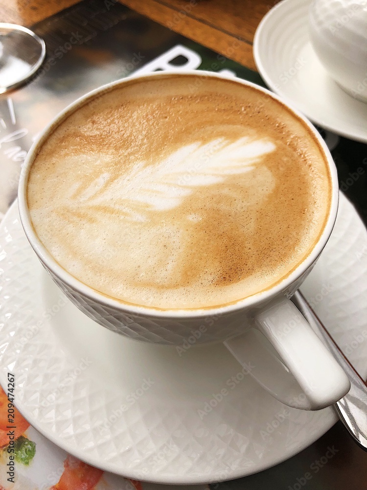 Delicious cappuccino coffee in a blue mug Delicious cappuccino coffee in a blue mug