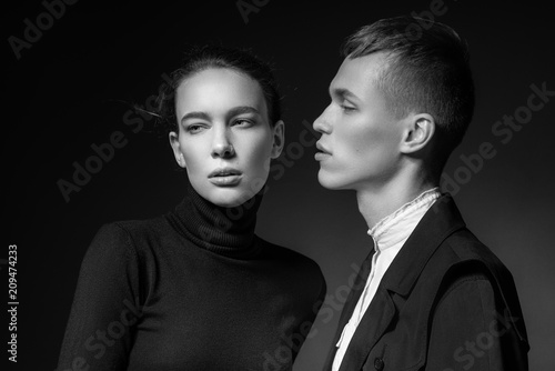 Young couple posing on dark background