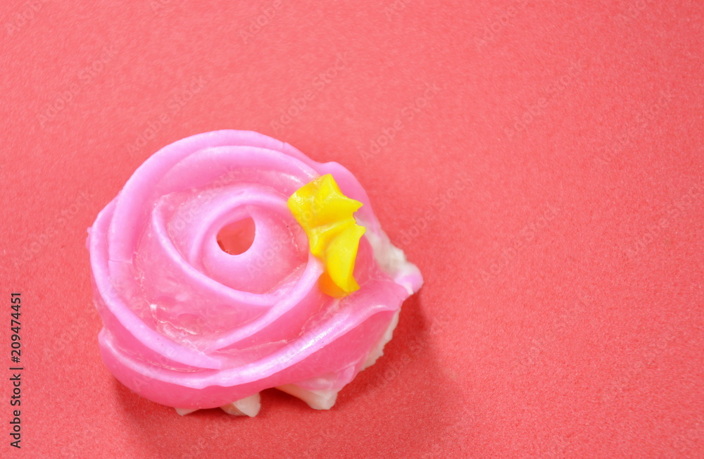 Allure colorful Thai candy with rose shape on red background Allure colorful Thai candy with rose shape on red background