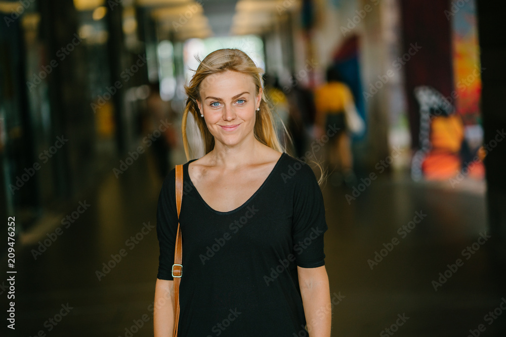 Portrait of a young, attractive, and photogenic blonde woman striking a fierce pose as she stands in the hallway of her campus. She is wearing casual and very comfortable clothes. Portrait of a young, attractive, and photogenic blonde woman striking a fierce pose as she stands in the hallway of her campus. She is wearing casual and very comfortable clothes.