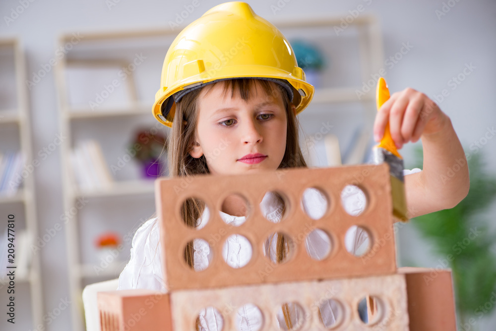 Young girl building with construction bricks Young girl building with construction bricks