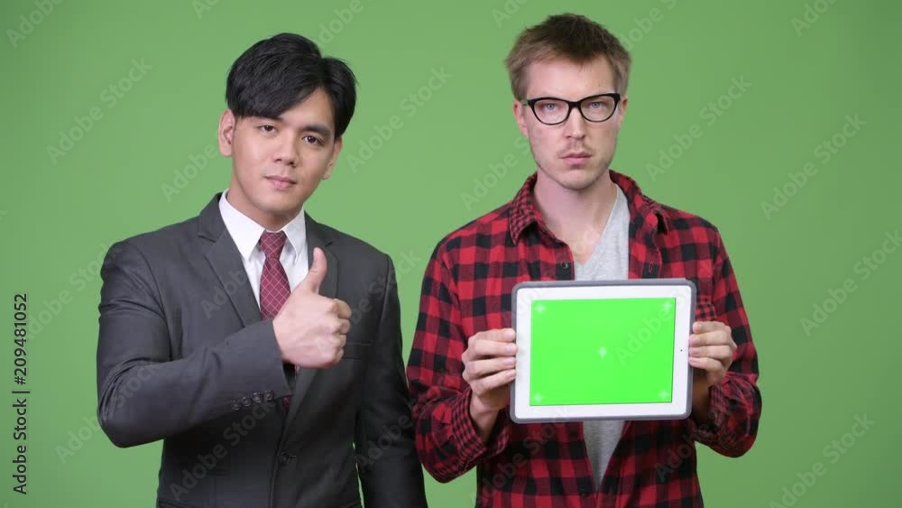 Young handsome Asian businessman and young Scandinavian businessman working together Young handsome Asian businessman and young Scandinavian businessman working together