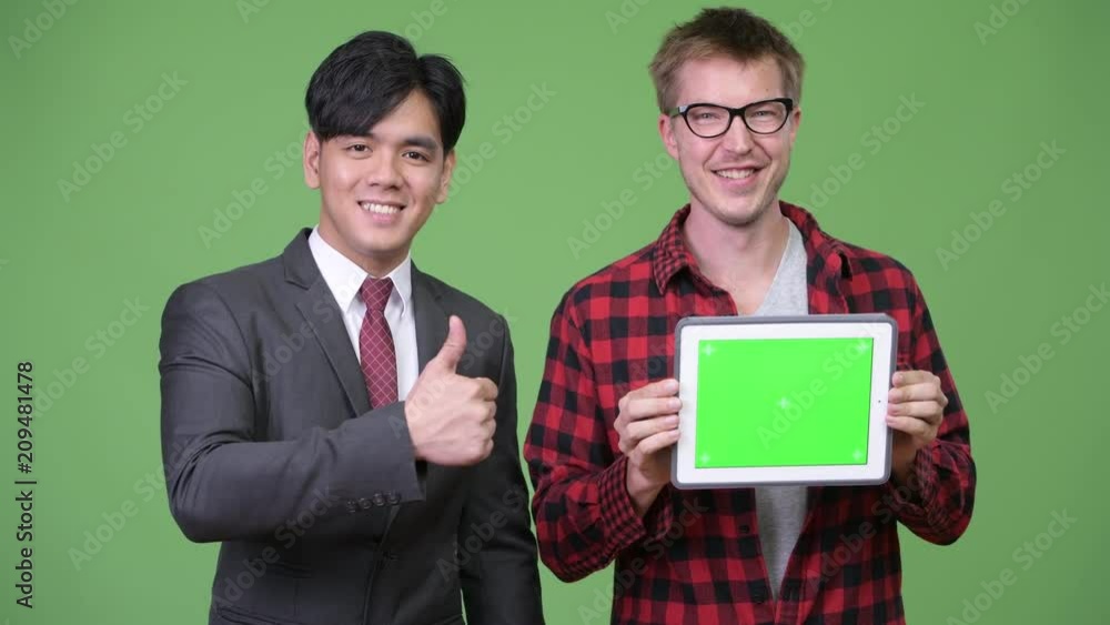 Young handsome Asian businessman and young Scandinavian businessman working together Young handsome Asian businessman and young Scandinavian businessman working together