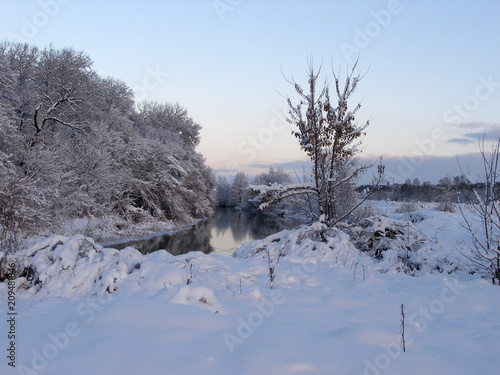 Winter landscape with a river, trees, snow