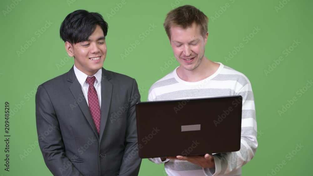Young handsome Asian businessman and young Scandinavian businessman working together Young handsome Asian businessman and young Scandinavian businessman working together