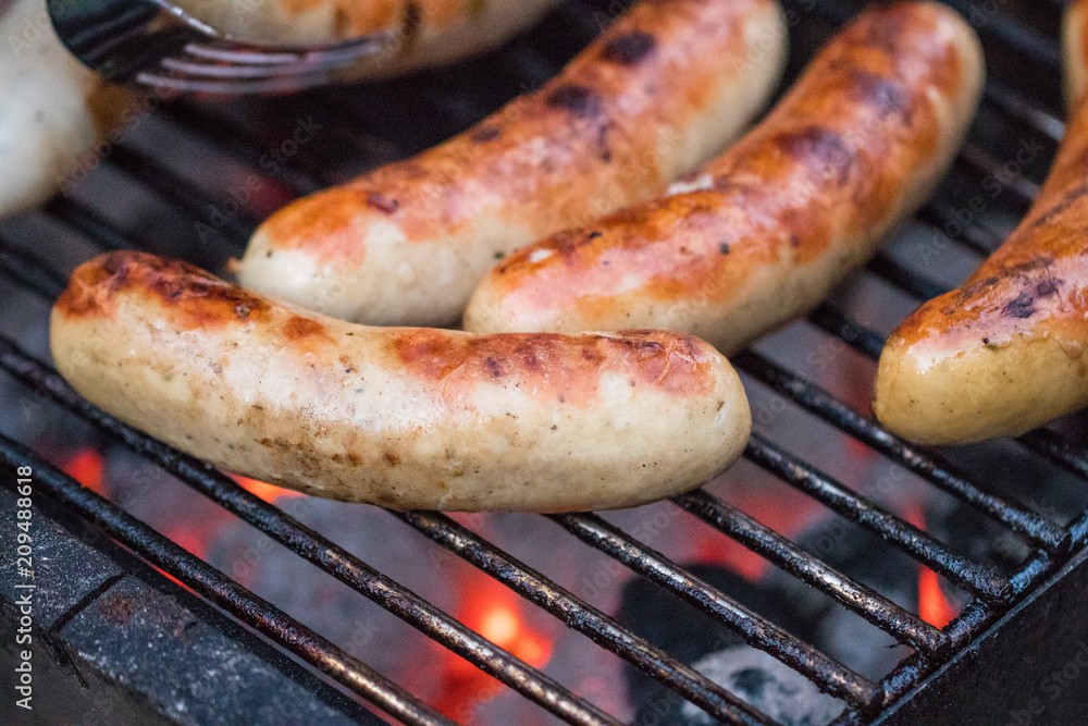 Grilling sausages on barbecue grill. Selective focus Grilling sausages on barbecue grill. Selective focus