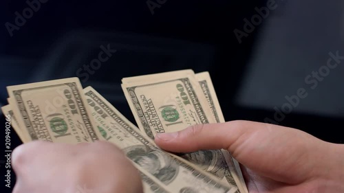 Woman counting dollar banknotes. Personal expenses, money calculation. Hands count money. Financial cash operations concept. Close up of woman hands holding cash dollars photo