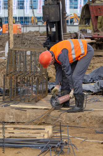 Khimki, Russia - June 14, 2018: Worker at the construction site sawing