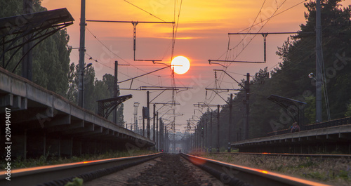 Railway at sunset, a platform of the railway with ozhidayuschimi passengers