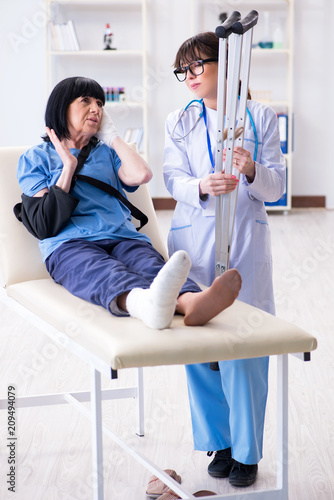 Doctor examining old mature woman after incident