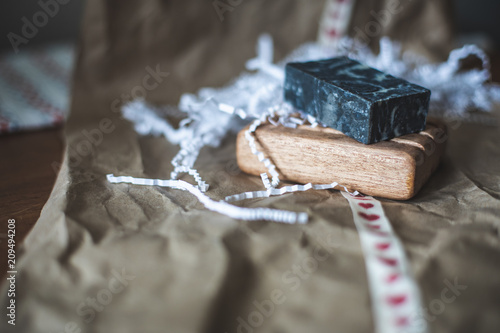 A bar of soap on a wooden soap holder