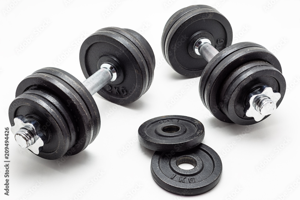 Black metal dumbbells on white background. Black metal dumbbells on white background.