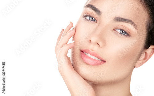 Beautiful brunette girl touching her face. Perfect fresh skin. Beauty portrait isolated on white background. Youth and skincare concept, cleansing  