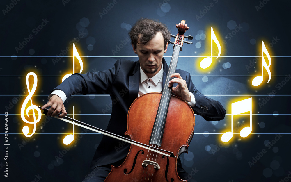 Fototapeta premium Young handsome cellist playing with music sheet background