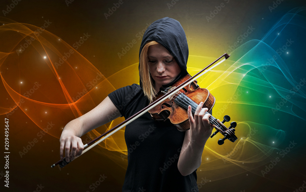 Fototapeta premium Serious classical violinist with fabled sparkling wallpaper