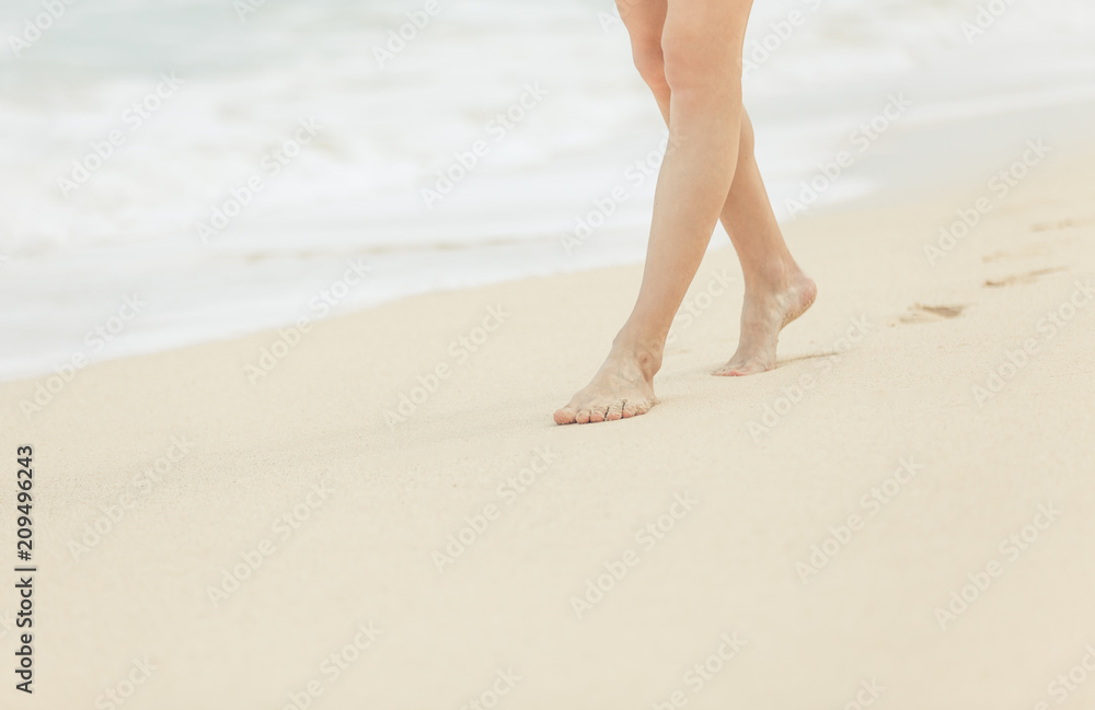 Feet walking down a whit sand beach. Feet walking down a whit sand beach.