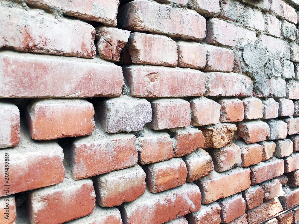 Piece of a ruined brick old wall background Piece of a ruined brick old wall background