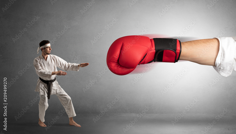 Little man fighting with a giant red boxing glove

