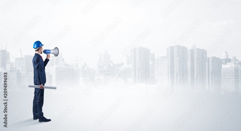 Young supervisor architect standing and looking at a big city panorama
Young supervisor architect standing and looking at a big city panorama