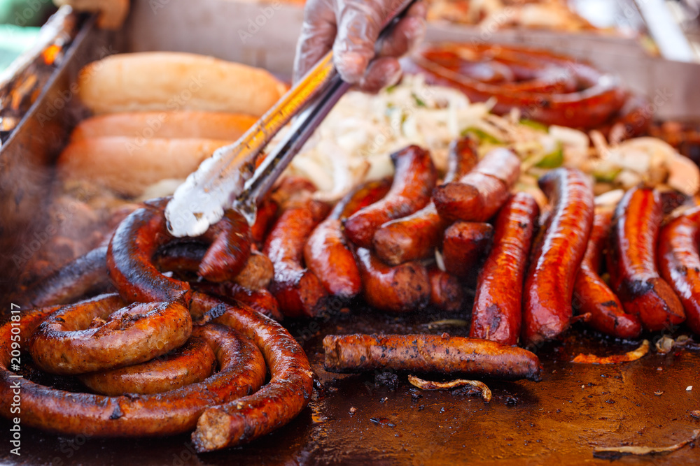 Fototapeta premium Italian Sausages Cooking at an Outdoor Food Event