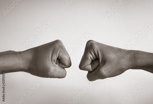 closeup of two hands bumping their fists.