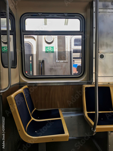 Interior of el train car in Chicago Loop, with view through window of passing train. © shellybychowskishots