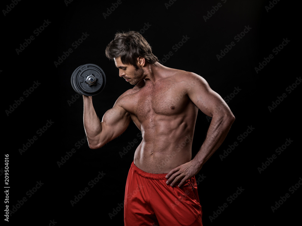 Man with bare chest lifting dumbbell