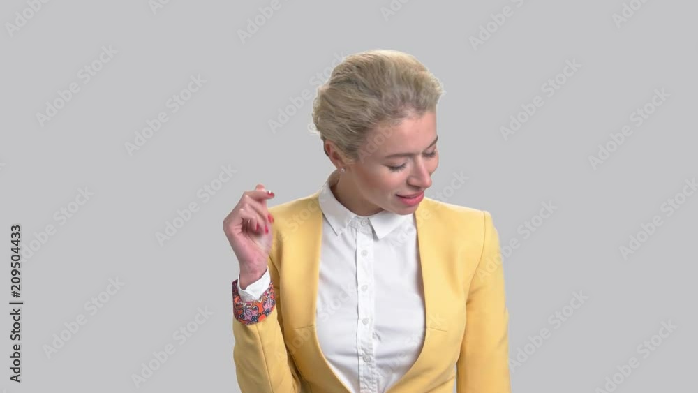 Pretty woman is singing on grey background. Portrait of charming lady is singing classical song. Passion and emotions. Pretty woman is singing on grey background. Portrait of charming lady is singing classical song. Passion and emotions.