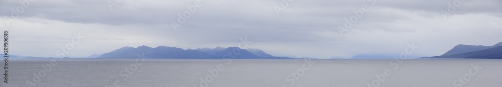 The Strait of Magellan at cloudy rainy day. Wide panoramic view. The Strait of Magellan at cloudy rainy day. Wide panoramic view.