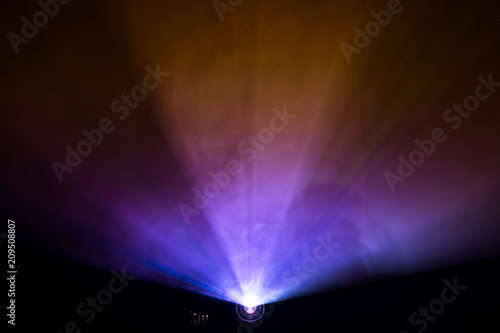 projector beautiful lighting . wide lens equipment for show presentation at night . smoke abstract background .