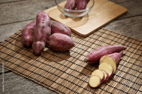 Raw sweet potato on wooden table