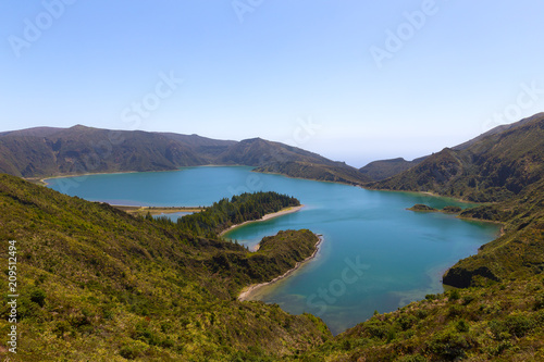 Lagoa do Fogo (Lake of Fire) on a clear day on Sao Miguel Island, Azores, Portugal. Mountainous landscape of volcanic island with the crater lake.