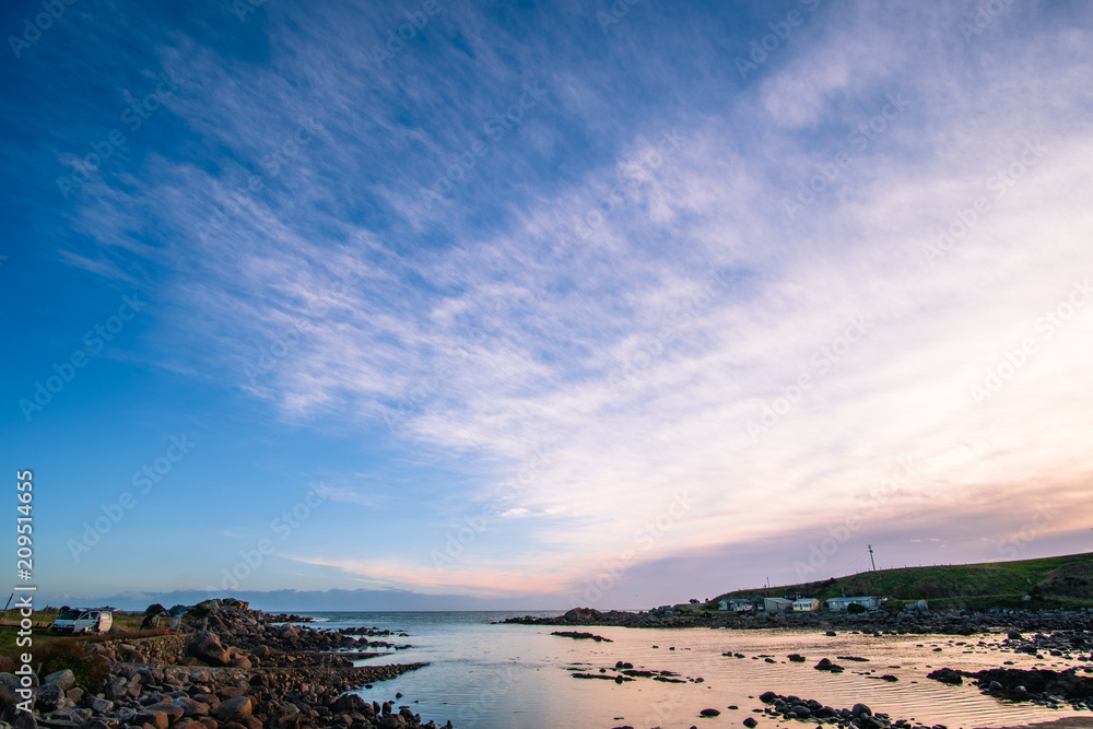 Obraz premium Beautiful scene of a landscape in a rural area beside the ocean at sunset. Cosy Nook, New Zealand.