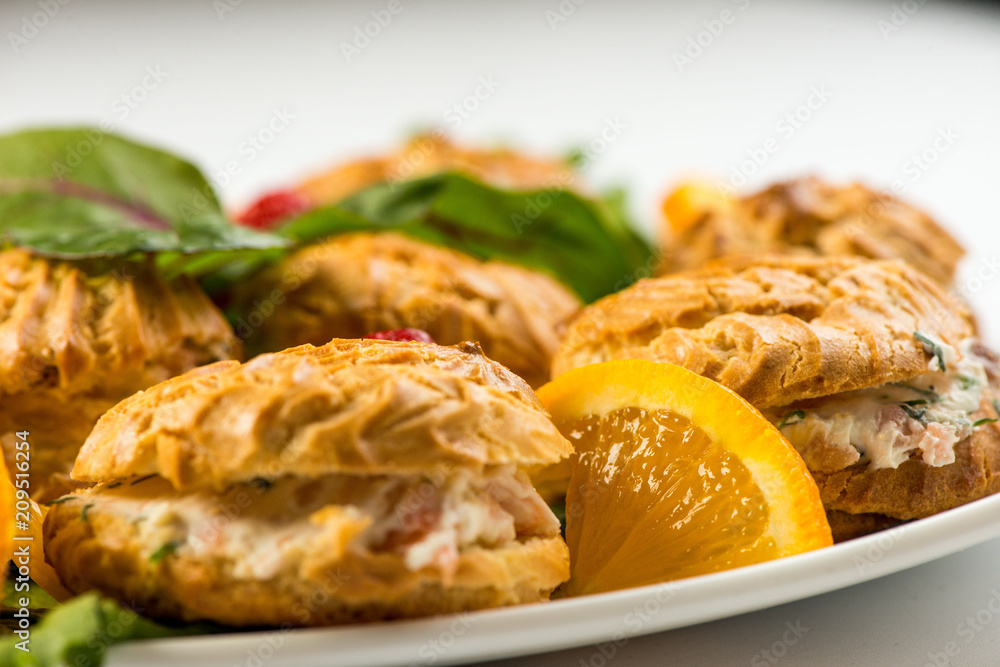Deep-fried doughnuts filled with coconut custard cream on white baking paper on light background Deep-fried doughnuts filled with coconut custard cream on white baking paper on light background