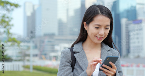Business woman sending sms on cellphone © leungchopan