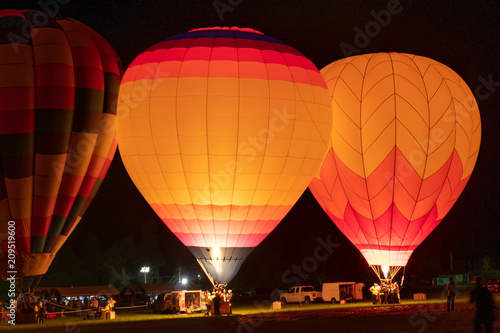Hot air balloons glowing at night