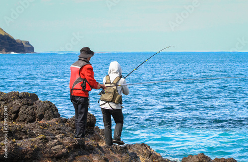Two fisherman on Cape Schank, Victoria, Australia.