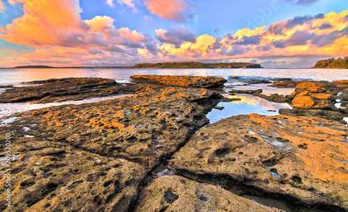 Sunset as seen from a natural rock jetty at Jervis Bay National Park, New South Wales, Australia. photo