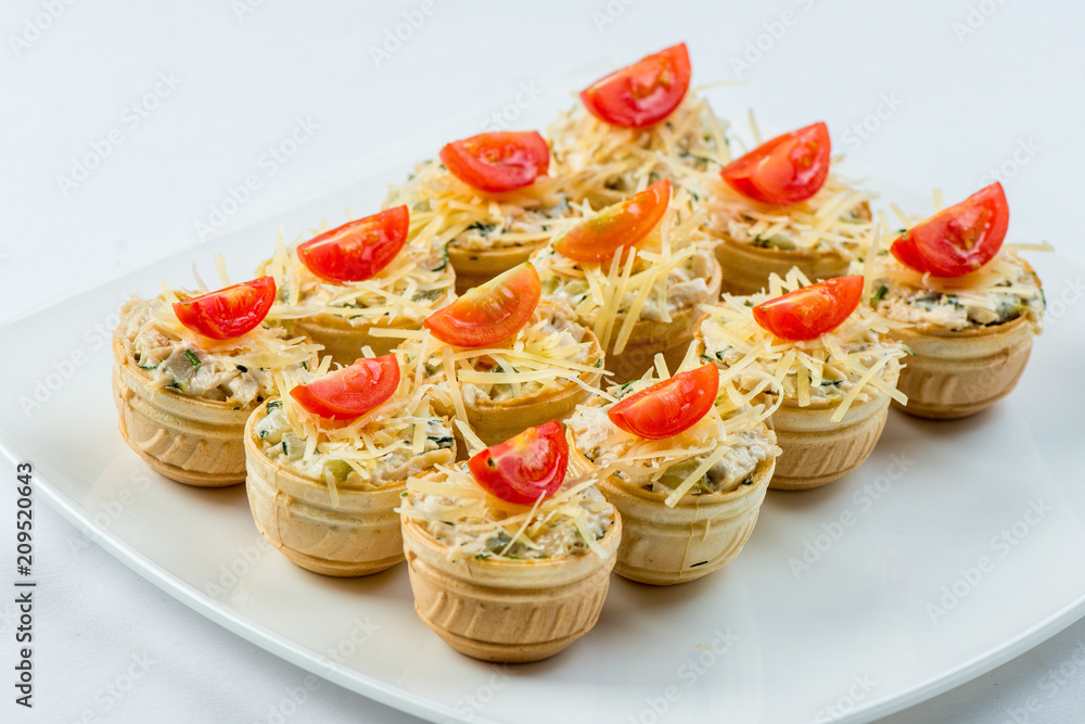 Three baguette slices with liver and apple pate and a thin tomato slice on top. Shallow DOF Three baguette slices with liver and apple pate and a thin tomato slice on top. Shallow DOF