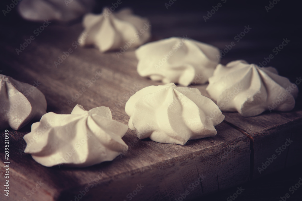 White marshmallows on wooden cutting board 