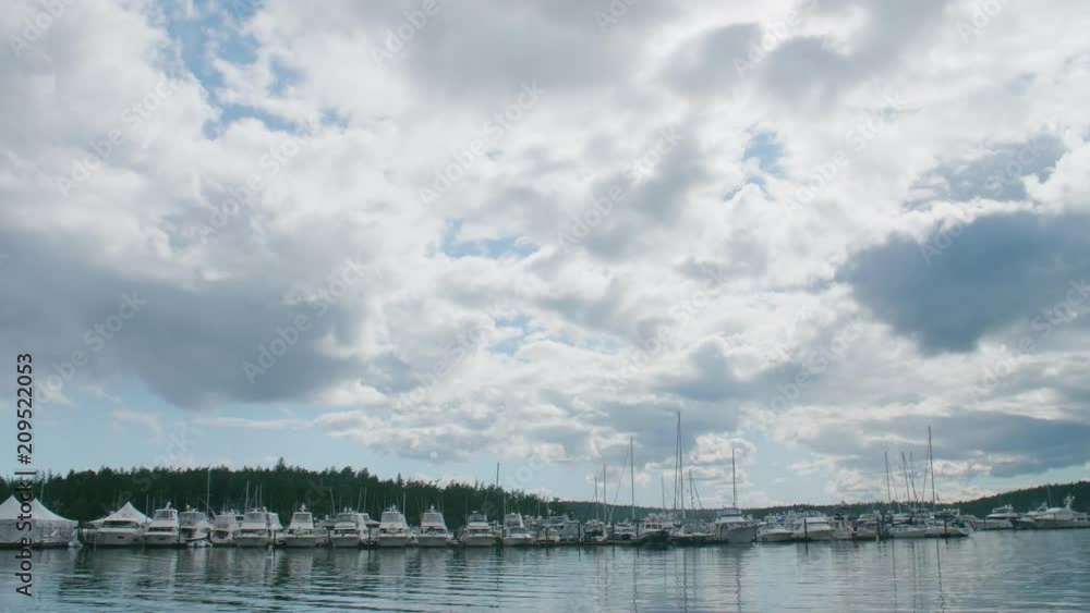 Roche Harbor Timelapse Clouds Above Yachts Lined Up On Dock - San Juan Island Washington USA Roche Harbor Timelapse Clouds Above Yachts Lined Up On Dock - San Juan Island Washington USA