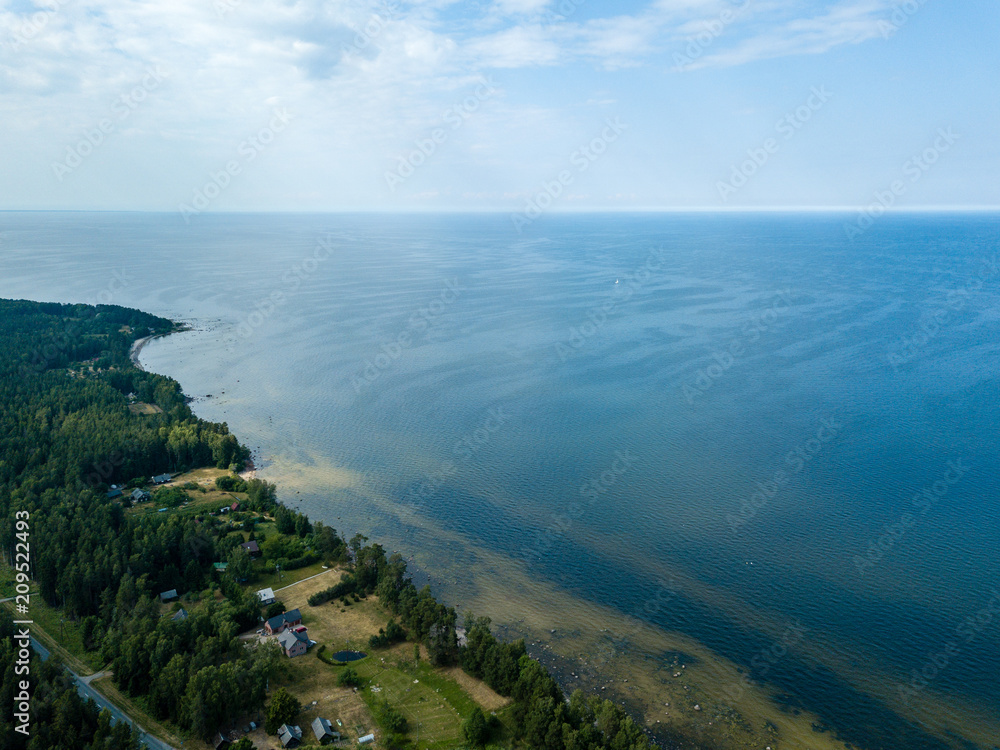 drone image. aerial view of Baltic sea shore with rocks and forest on land