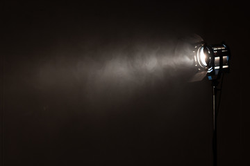Studio spotlight using for background production film . silhouette blurred led lights with smoke in dark room . electric tools set for photography , video maker , cinematography