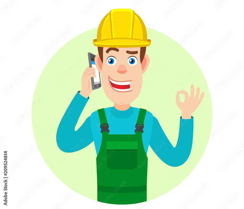 Builder talking on mobile phone and showing a okay hand sign