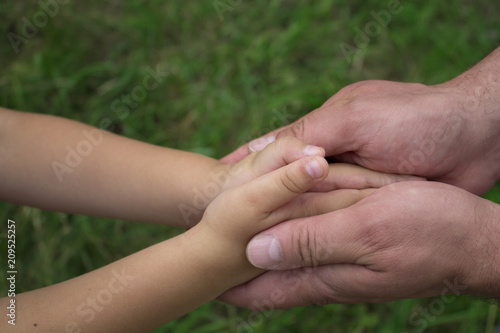 children's palms in the hands of the father close-up © Laura Сrazy