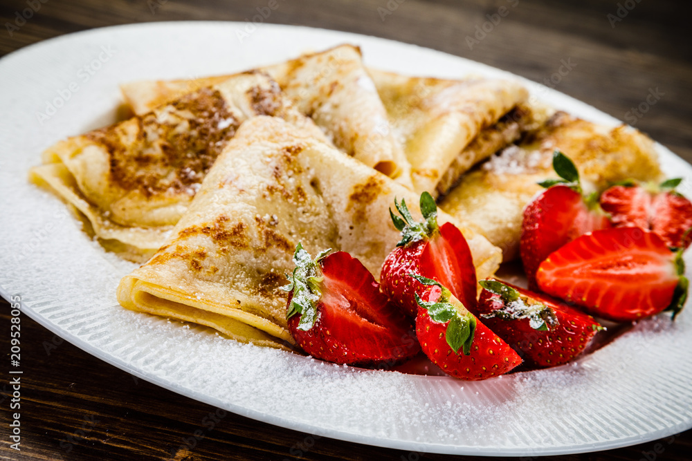 Crepes with cream and strawberries Crepes with cream and strawberries