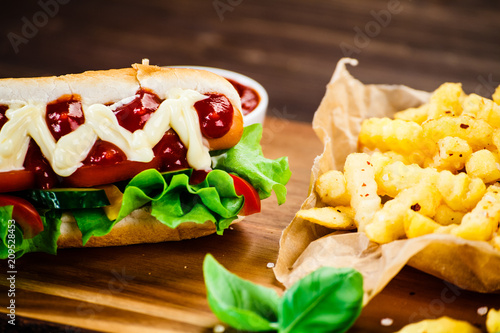 Hot dog and french fries on cutting board