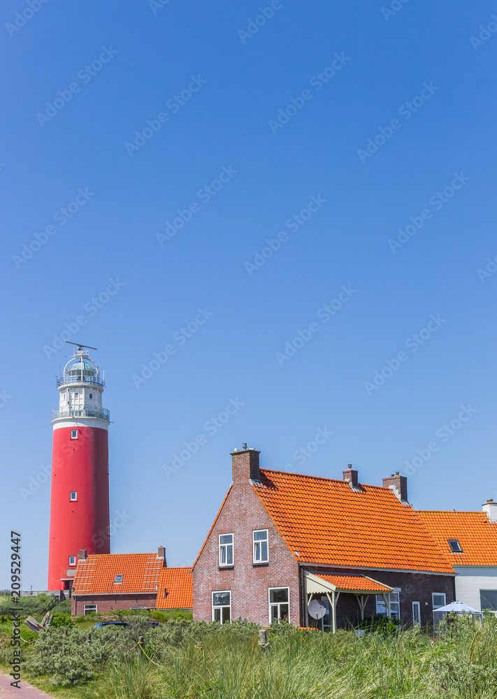 Houses and red lighthouse on Texel island, The Netherlands